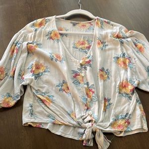 Charlotte Russe cream colored quarter sleeve blouse with flowers in size medium